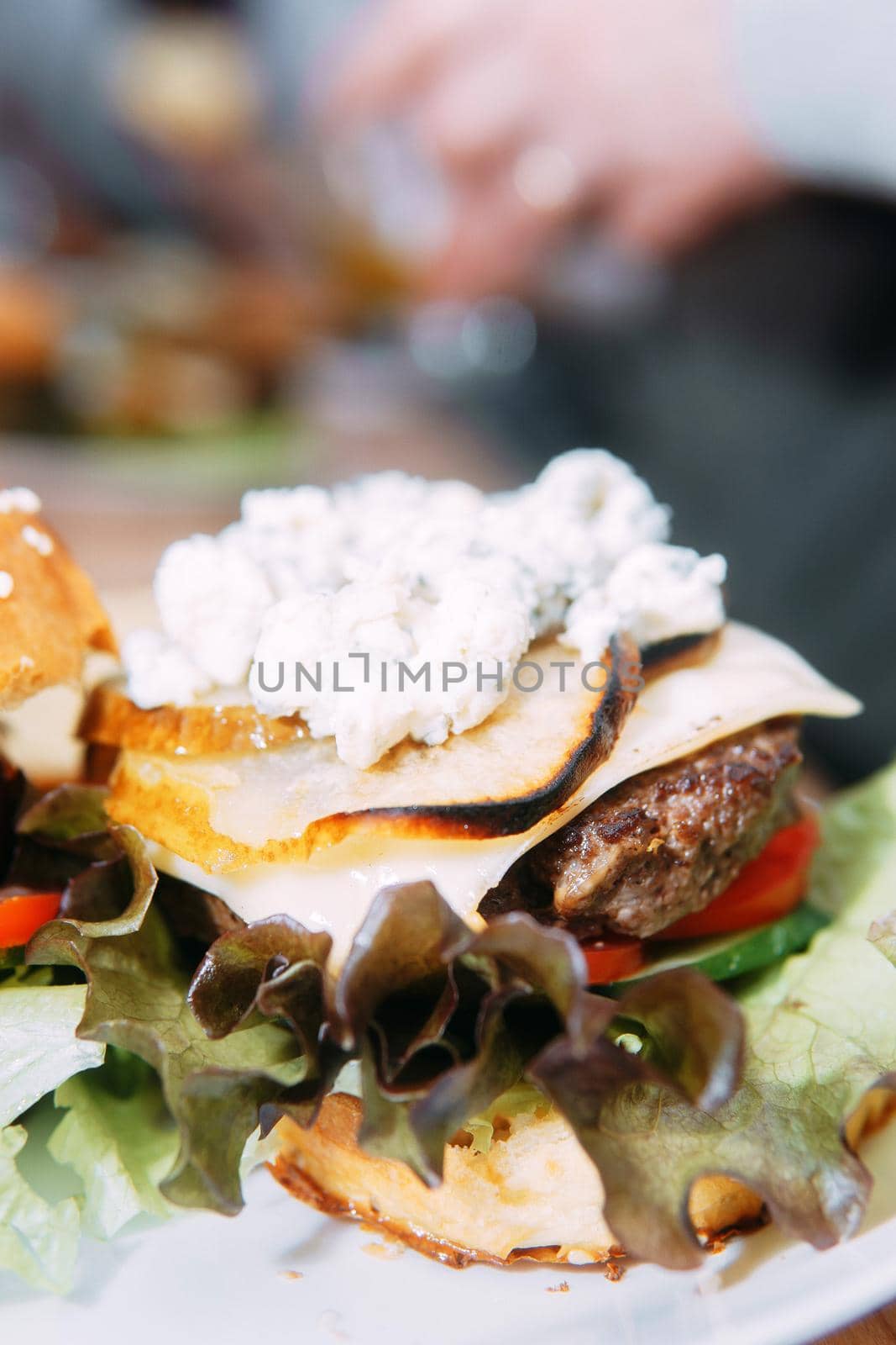 Burgers with beef and vegetables. Close up. Delicious burgers in a cooking class. Burger with onion sauce.