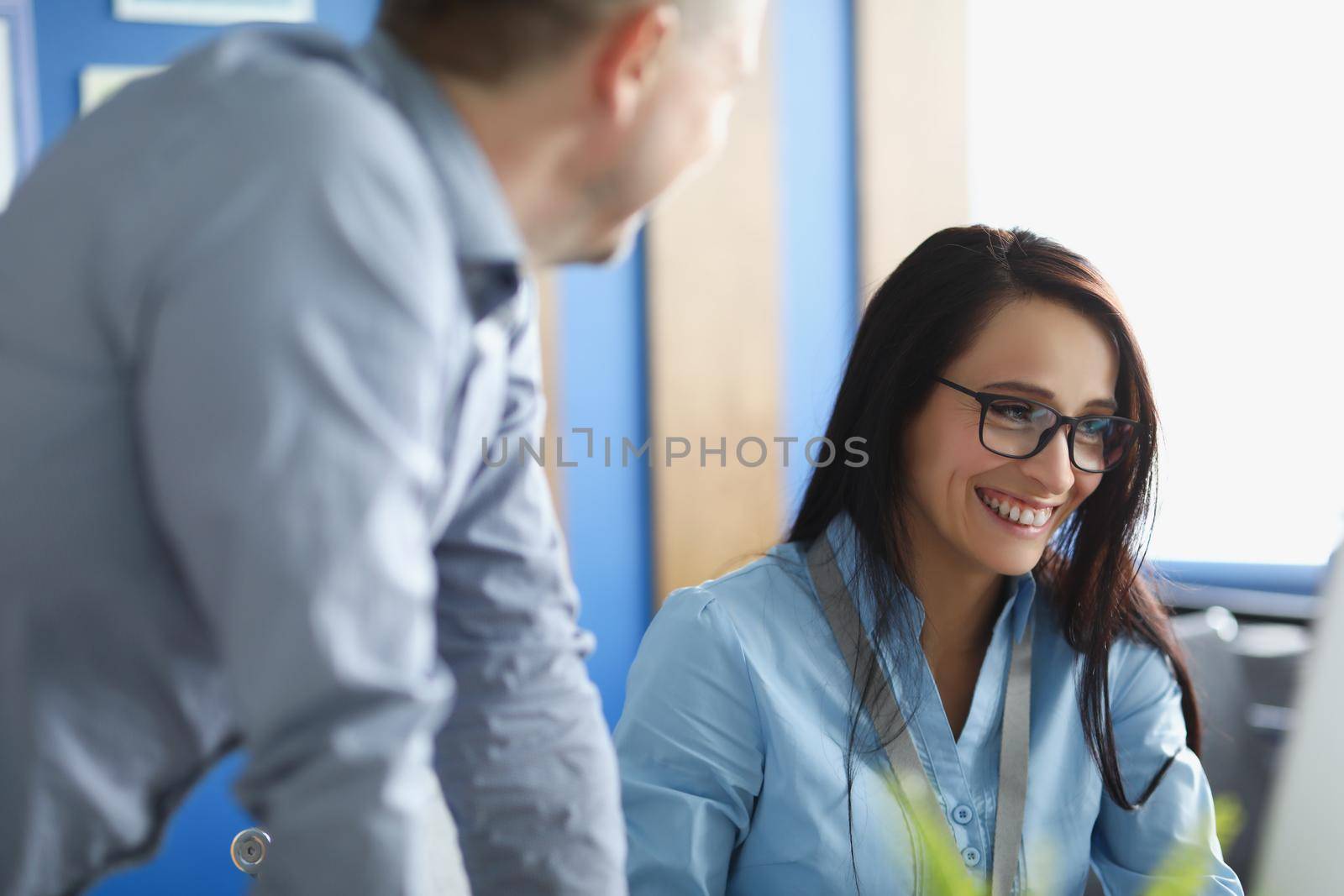 Coworkers man and woman smile and laugh on joke, work friends by kuprevich