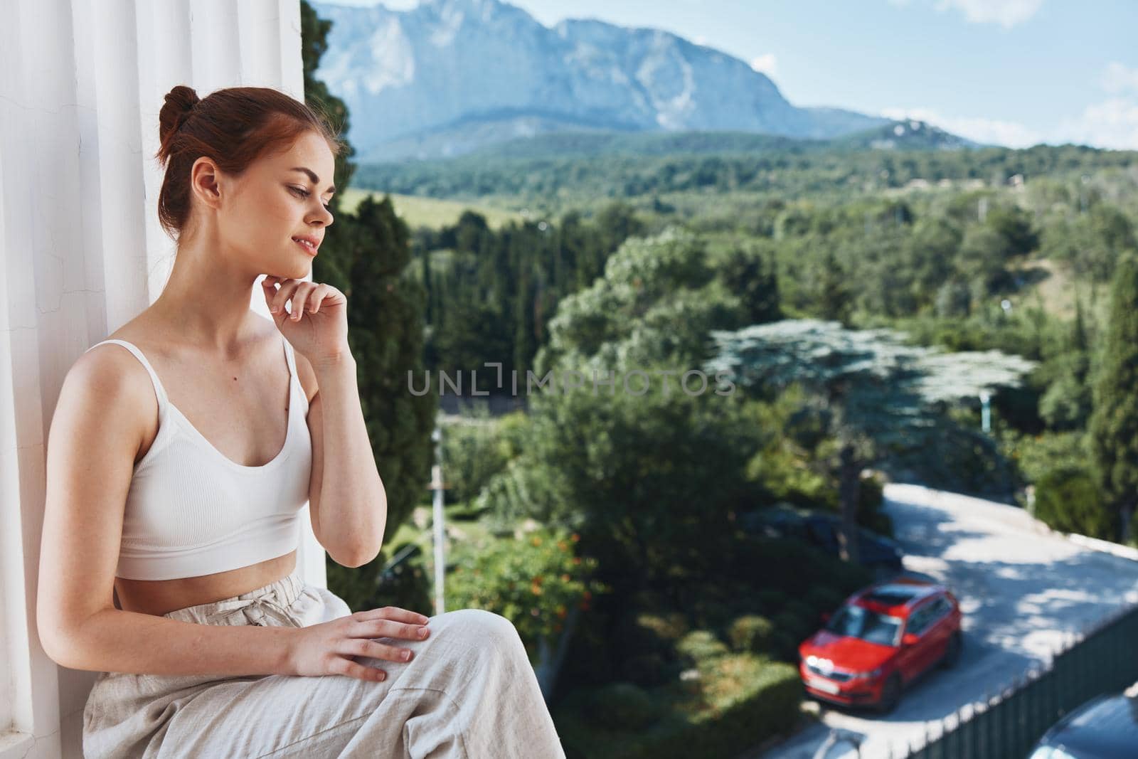 woman sitting on a balcony outdoors hotel vacation luxury. High quality photo