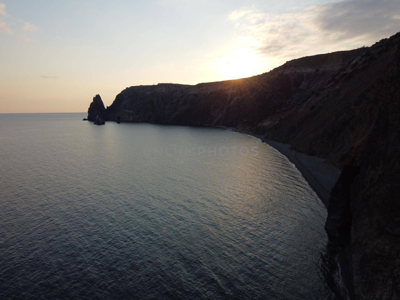 Aerial panoramic view of beautiful sunset above sea. Beautiful seascape. Sun glare, small waves on the water surface. Evening. Horizon. Nobody. No people. Copy space. Never-ending beauty of nature