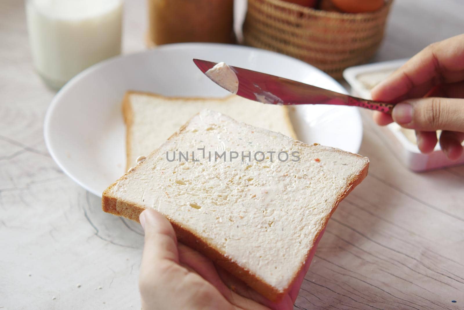 butter spreading on a bread close up .