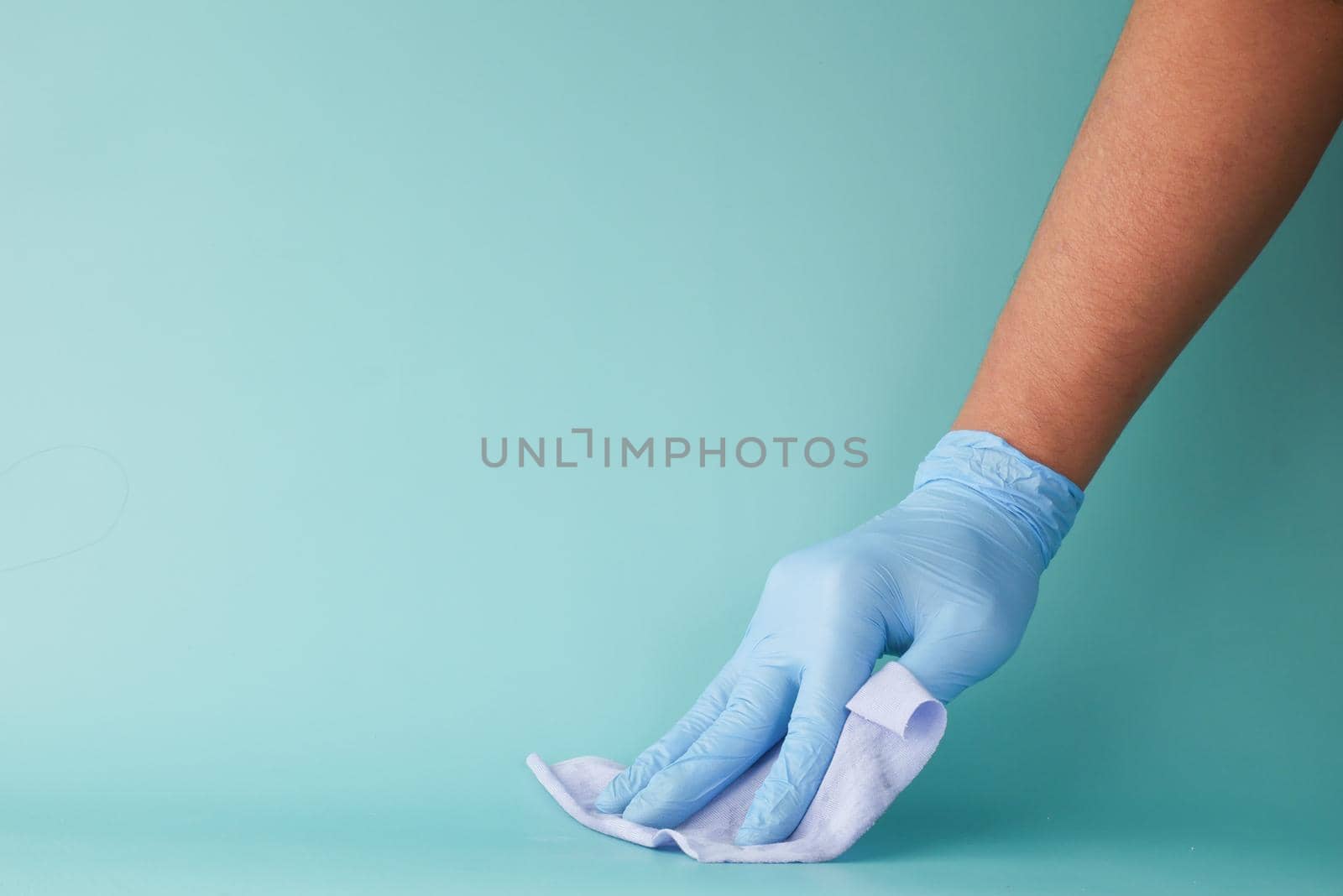 close up of person hand cleaning table with cloth .
