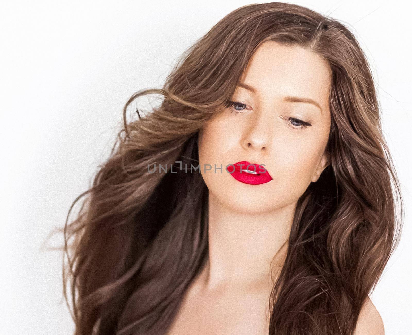 Hairstyle model and beauty face closeup. Beautiful woman with long straight brown hair styled in curly waves, classic glamour style and luxury fashion portrait.