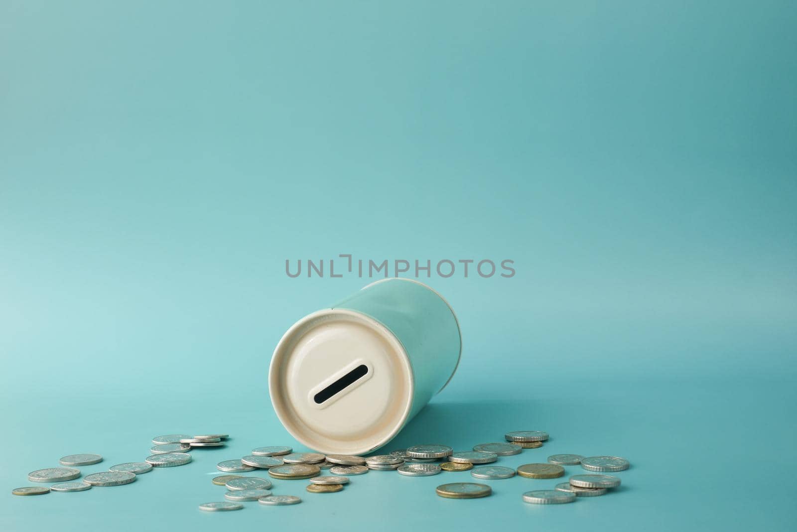 saving coins jar and calculator on table .