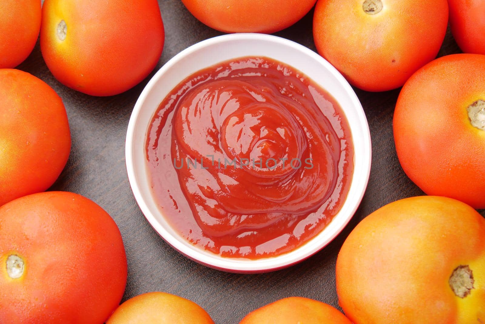 tomato sauce in a small jar with fresh tomato on table ,