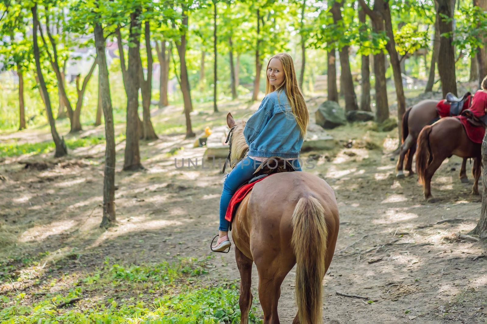 Beautiful woman riding a horse in countryside by galitskaya