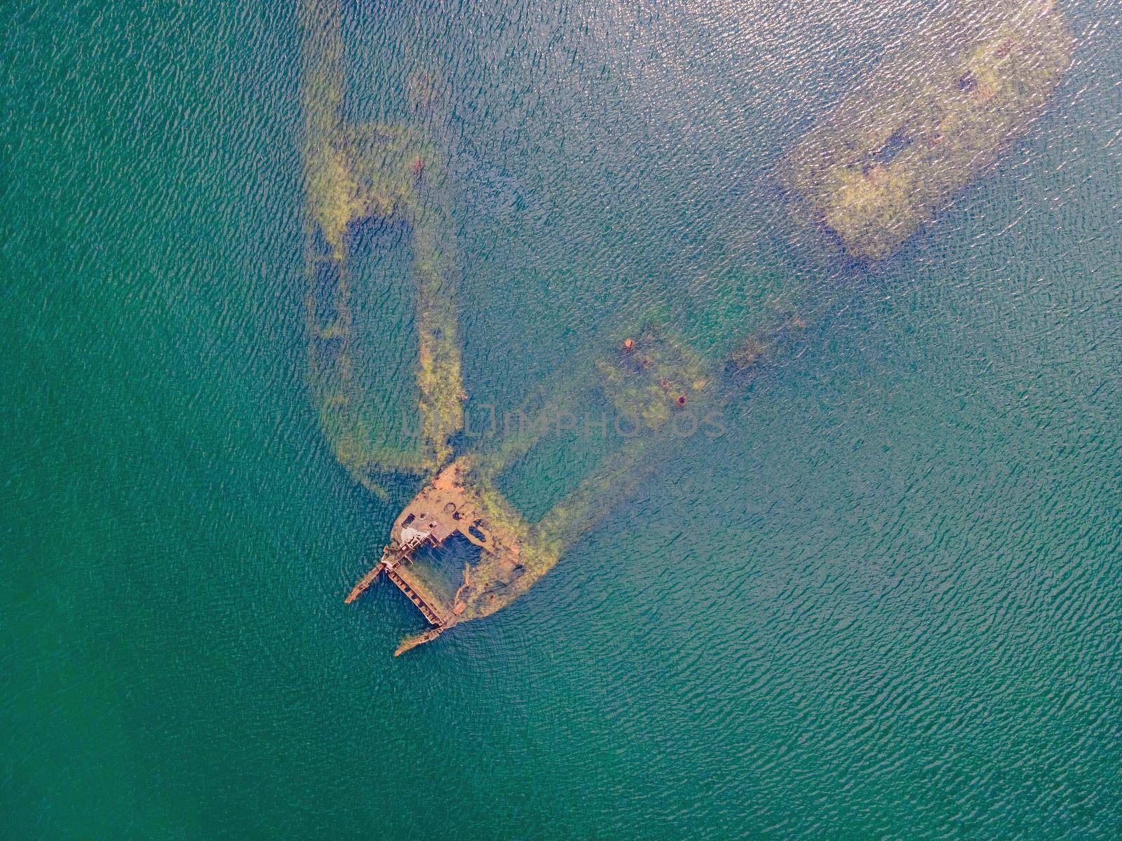 Abandoned broken shipwreck sticking out of the sea.