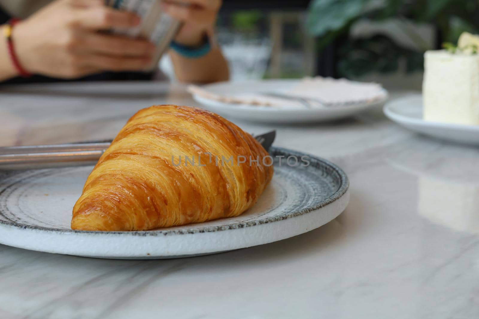 Freshly baked croissant shiny in the coffee cafe