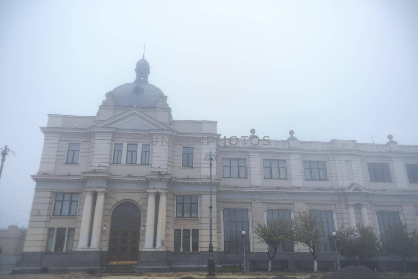 Vintage building of railway station in fog weather.