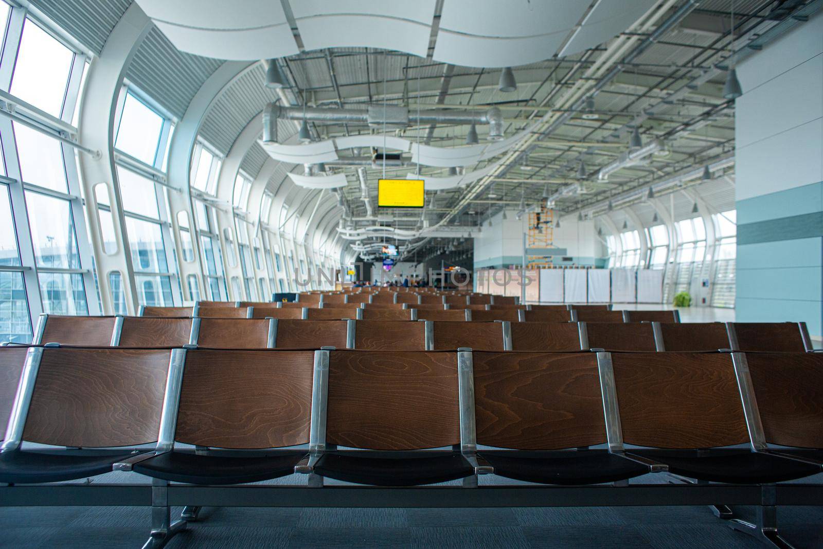 Deserted airport terminal. Rows of empty seats in the waiting room by Try_my_best