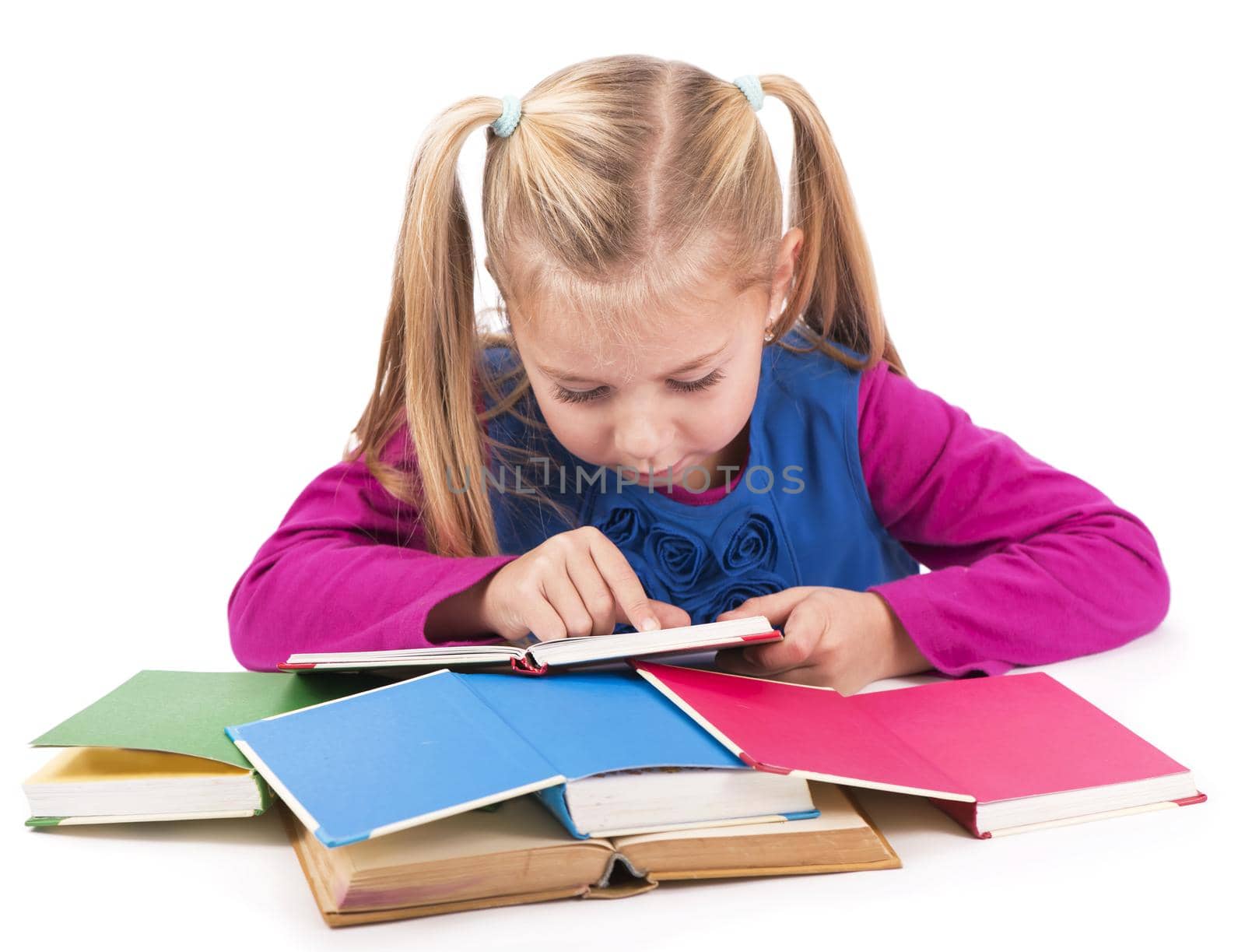 Little smart girl holding a book and reading it, on a white background by aprilphoto