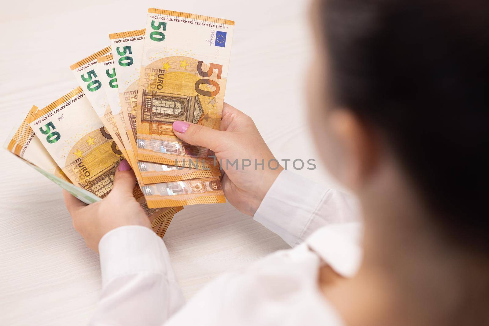 Close up of Person Hands Counting Money, Salary, Income, Savings, Money, Euros. Woman count euro 50 banknotes. Family budget. Count euros, Money counting.