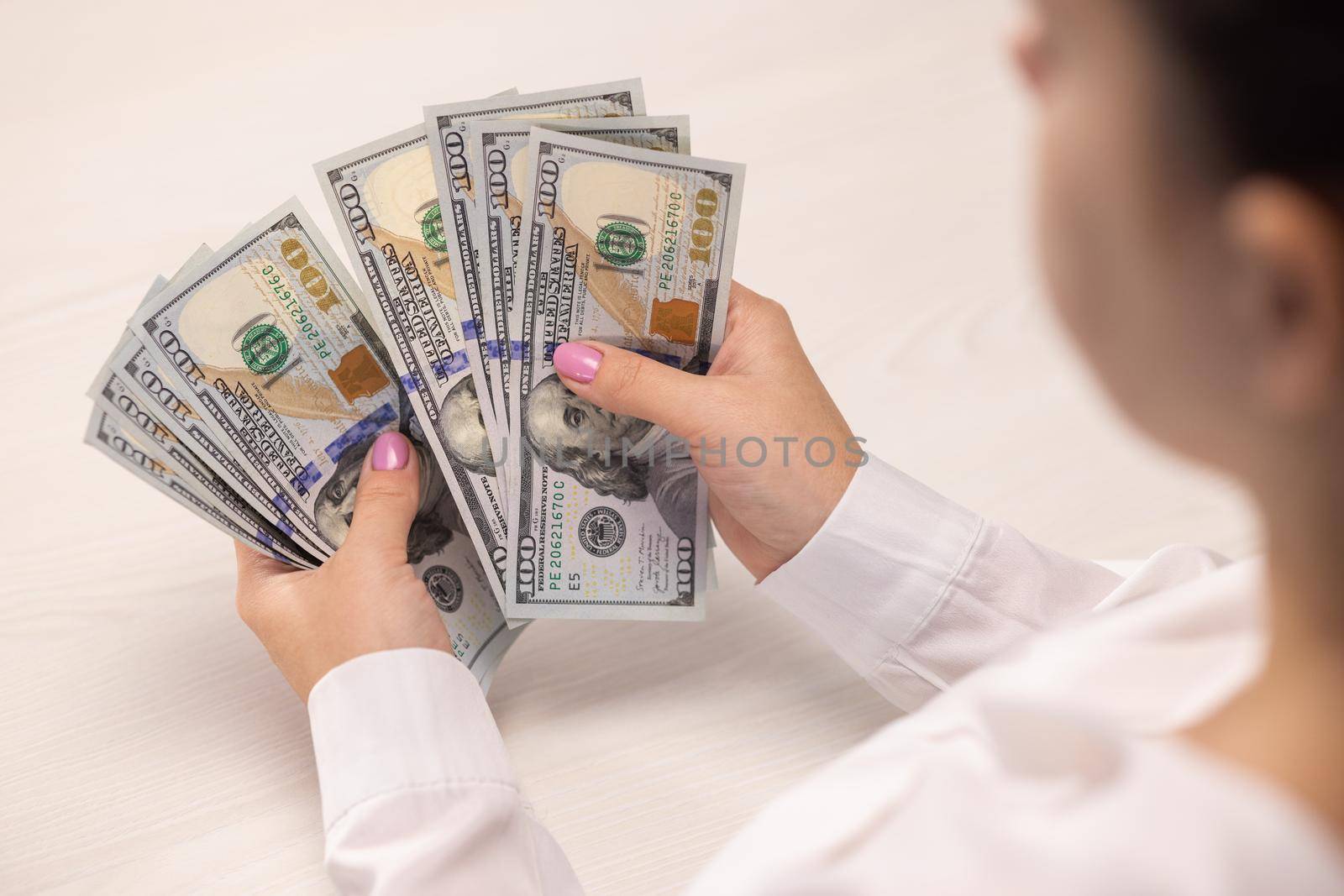 Successful business woman counting dollar banknotes money. Accepting bribe. taking money under the table. Economic debt. Financial crisis concept. Corruption. Envelope salary. Tax cheating.