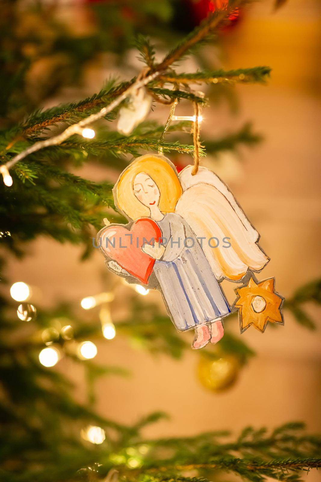 Decorated Christmas tree, angel in Orthodox church on Christmas eve. Religious Christmas celebration concept