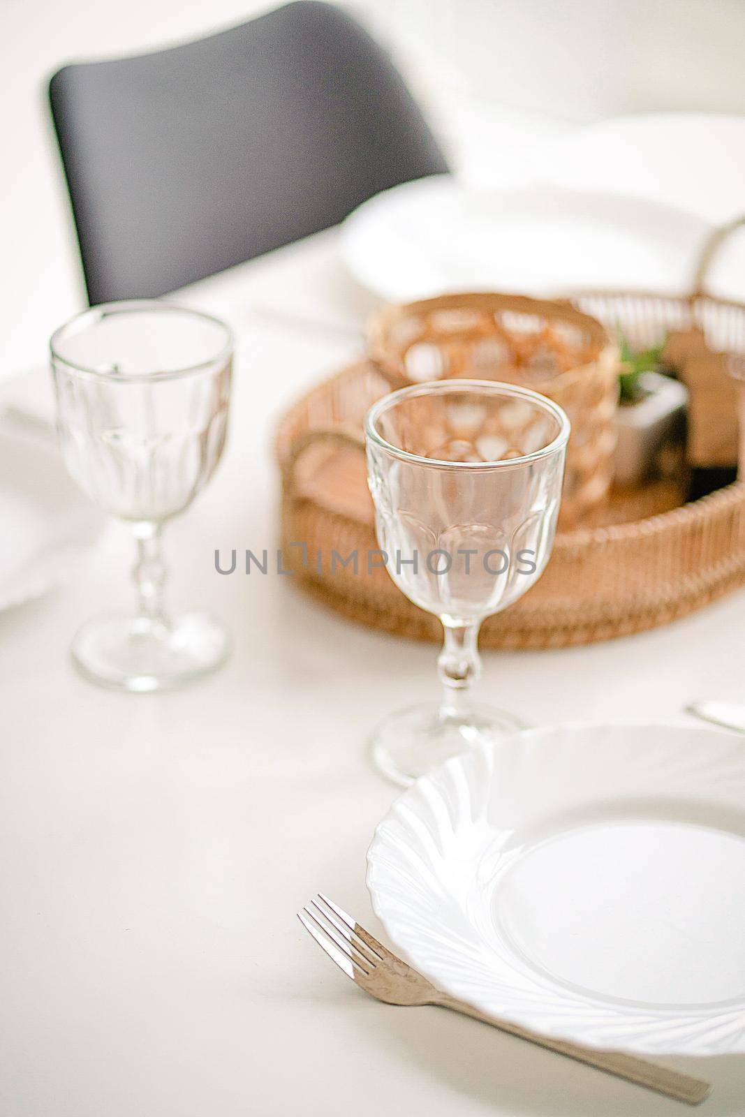 Two Empty Wine Glasses on a Dining Table with a White Tablecloth, Table Decoration, Table Setting. Close-up. High quality photo