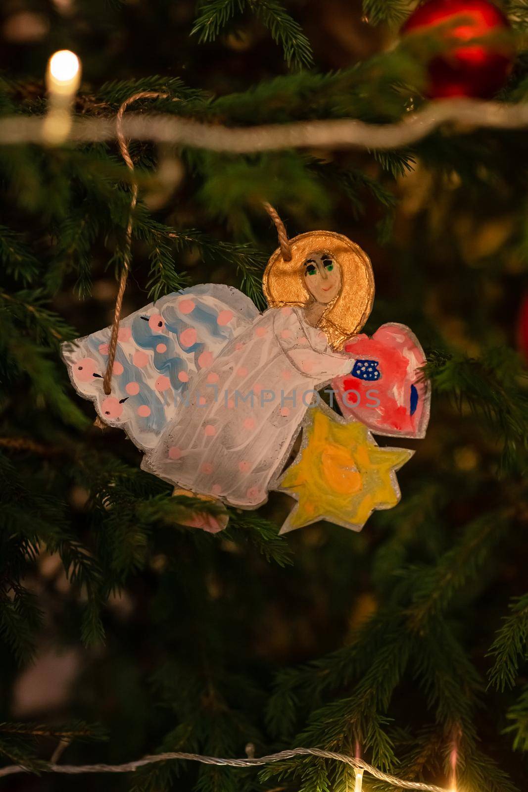 Decorated Christmas tree, angel in Orthodox church on Christmas eve. Religious Christmas celebration concept