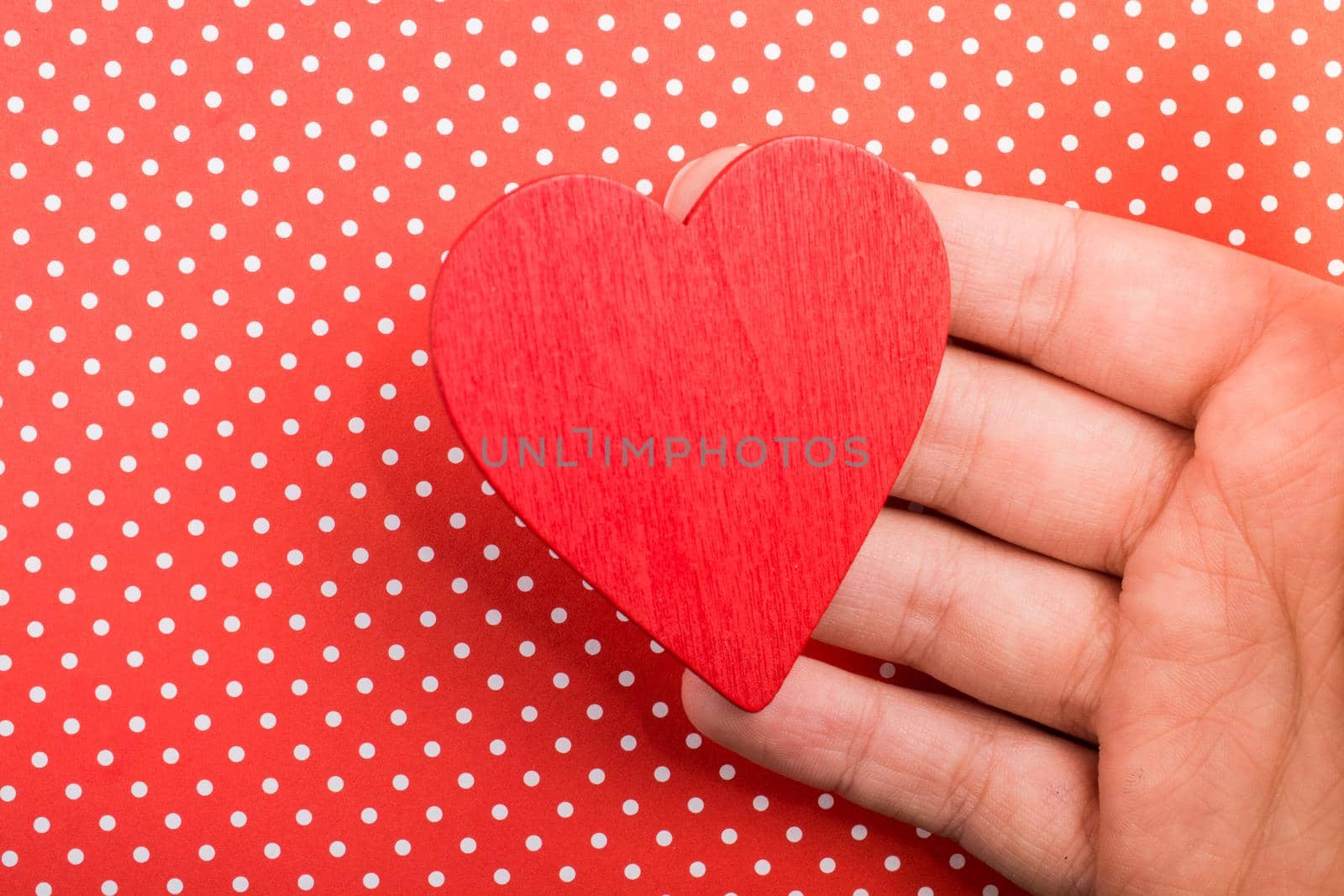 Red color heart shaped object in hand by berkay