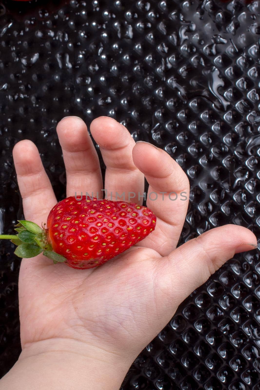 Sweet and ripe strawberry fruit in hand by berkay