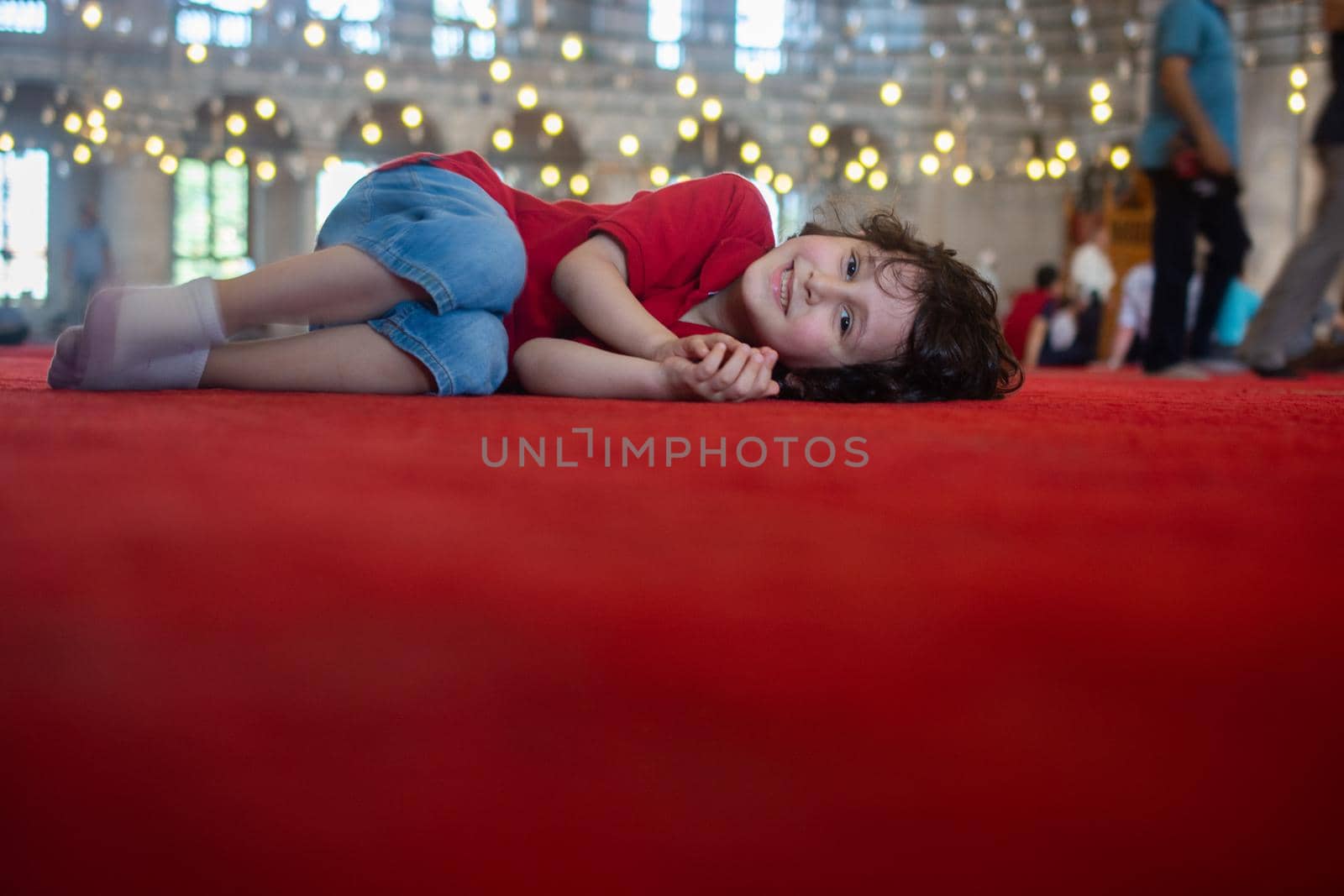 Little cute boy with happy smiling lying down indoors