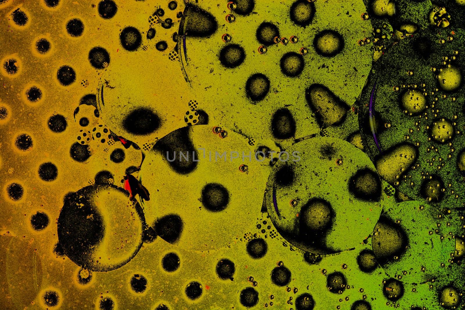 Macro shot of water oil emulsion over colored background by berkay