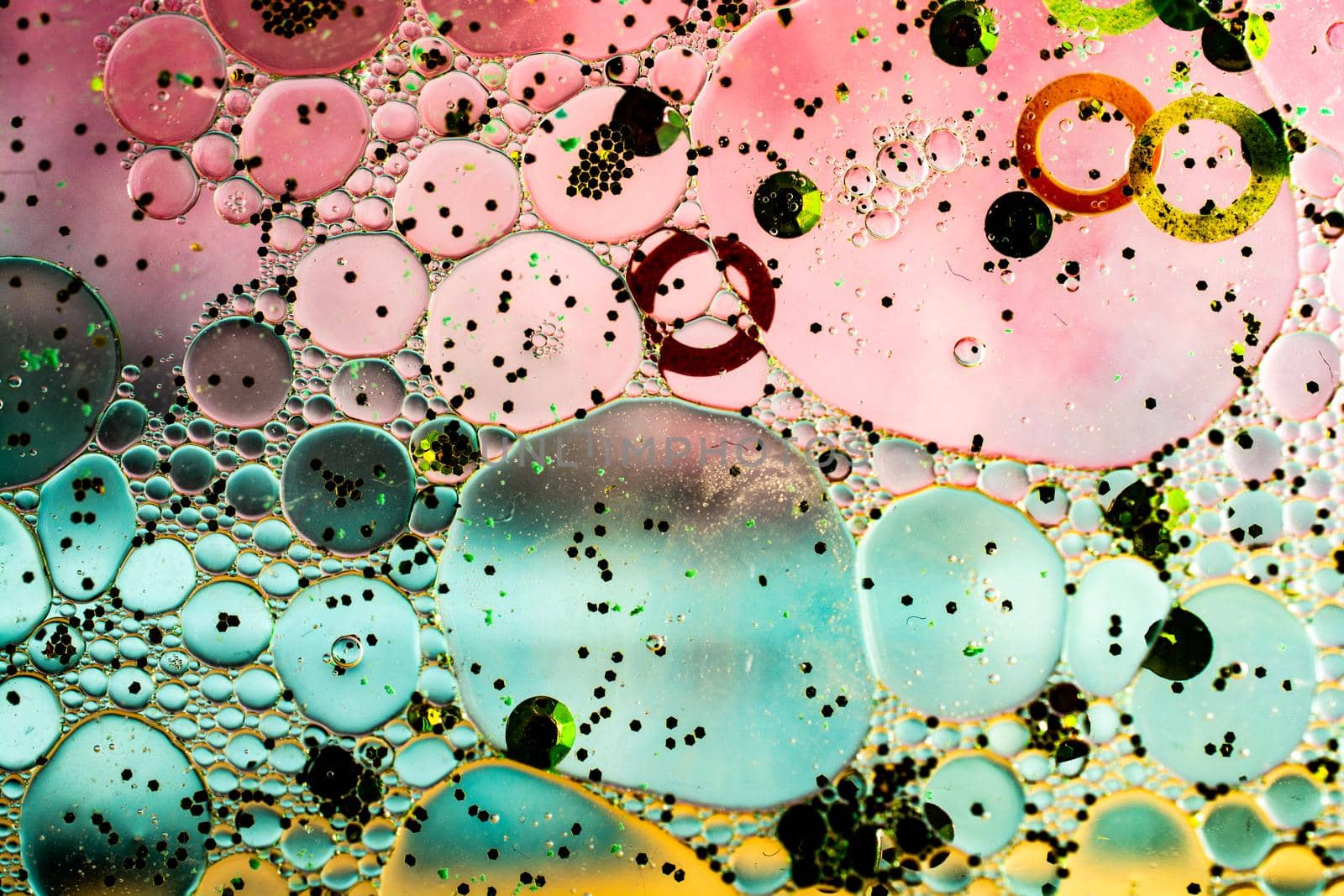 Macro shot of water oil emulsion over colored background by berkay