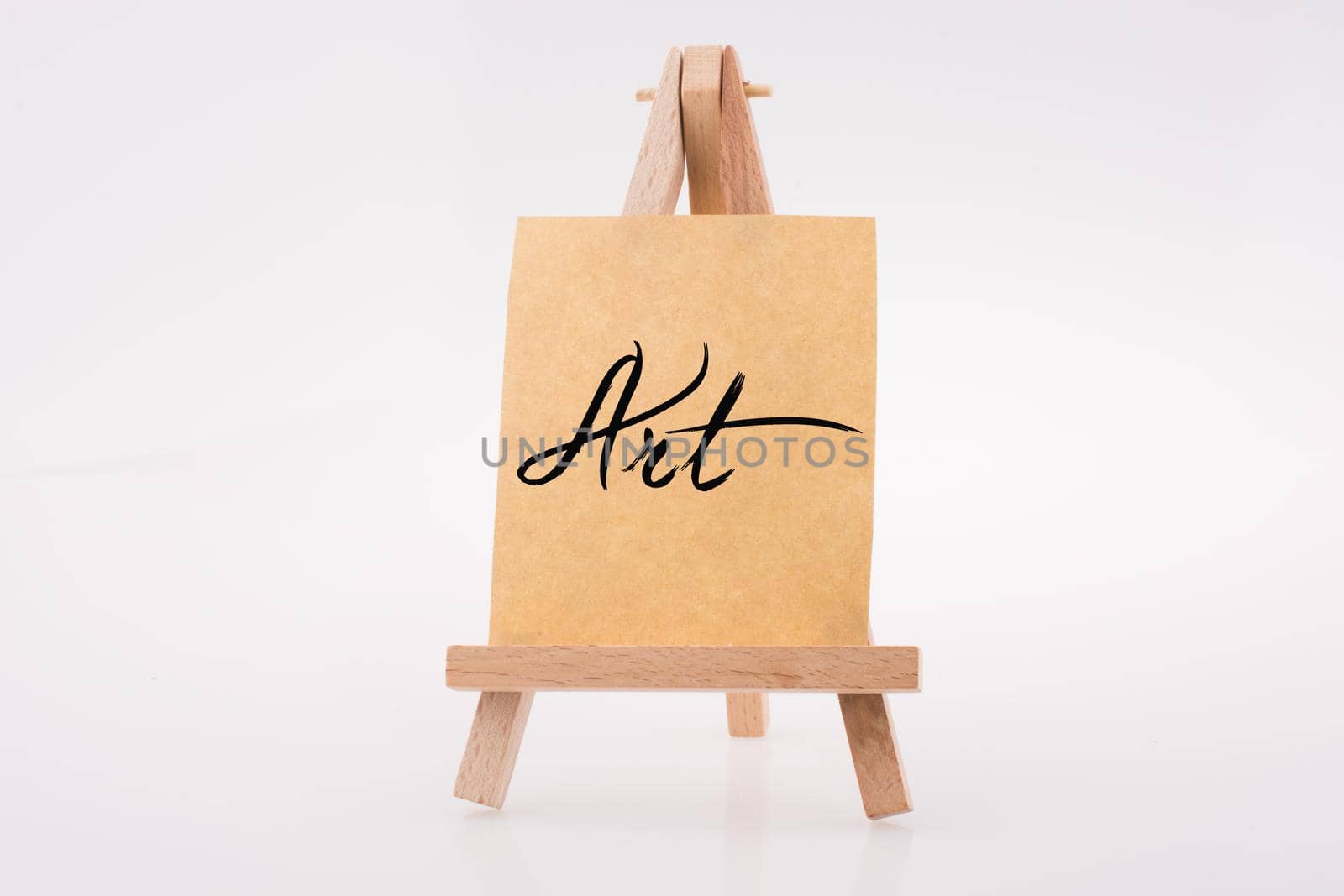 Brown color  notepaper on a painting tripod on white background