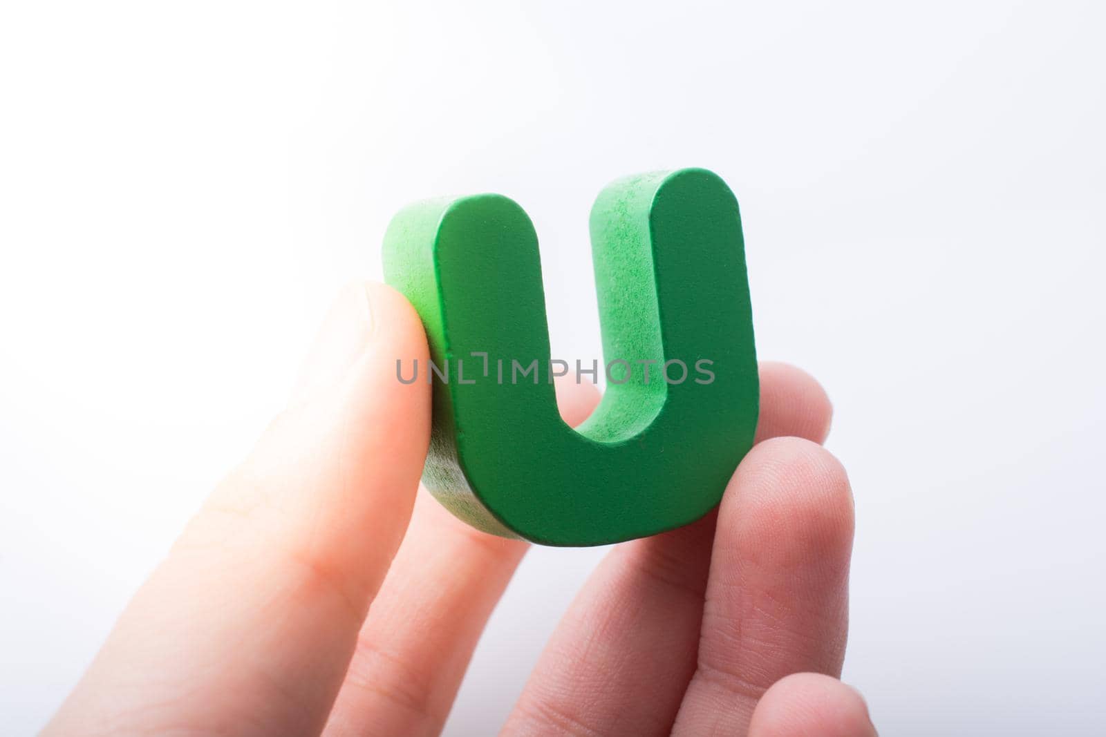 Hand holding Letter cube U of  Alphabet by berkay