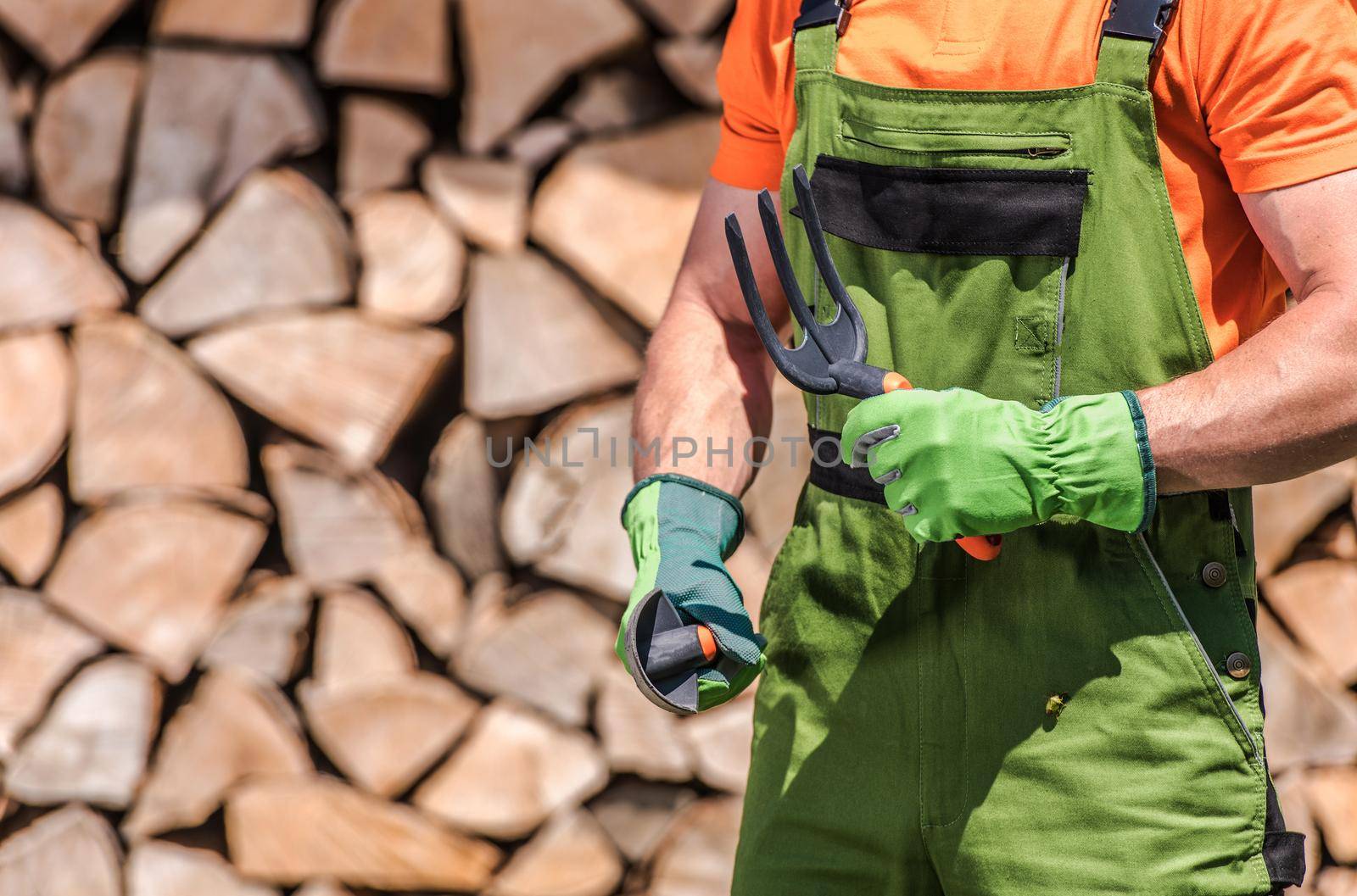 Caucasian Men in His 30s with Garden Tools in His Hands Preparing For the Job. Backyard Garden Work Theme