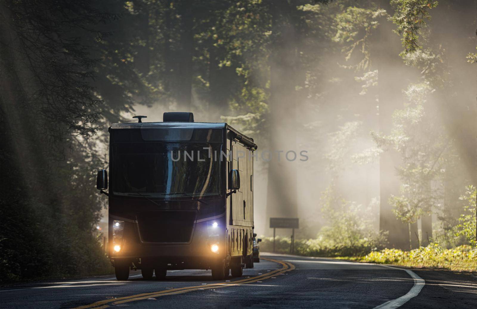 Class A Diesel Pusher Motorhome RV on a Scenic California Highway 101 Covered by Coastal Fog. Motor Coach Road Trip Vacation.