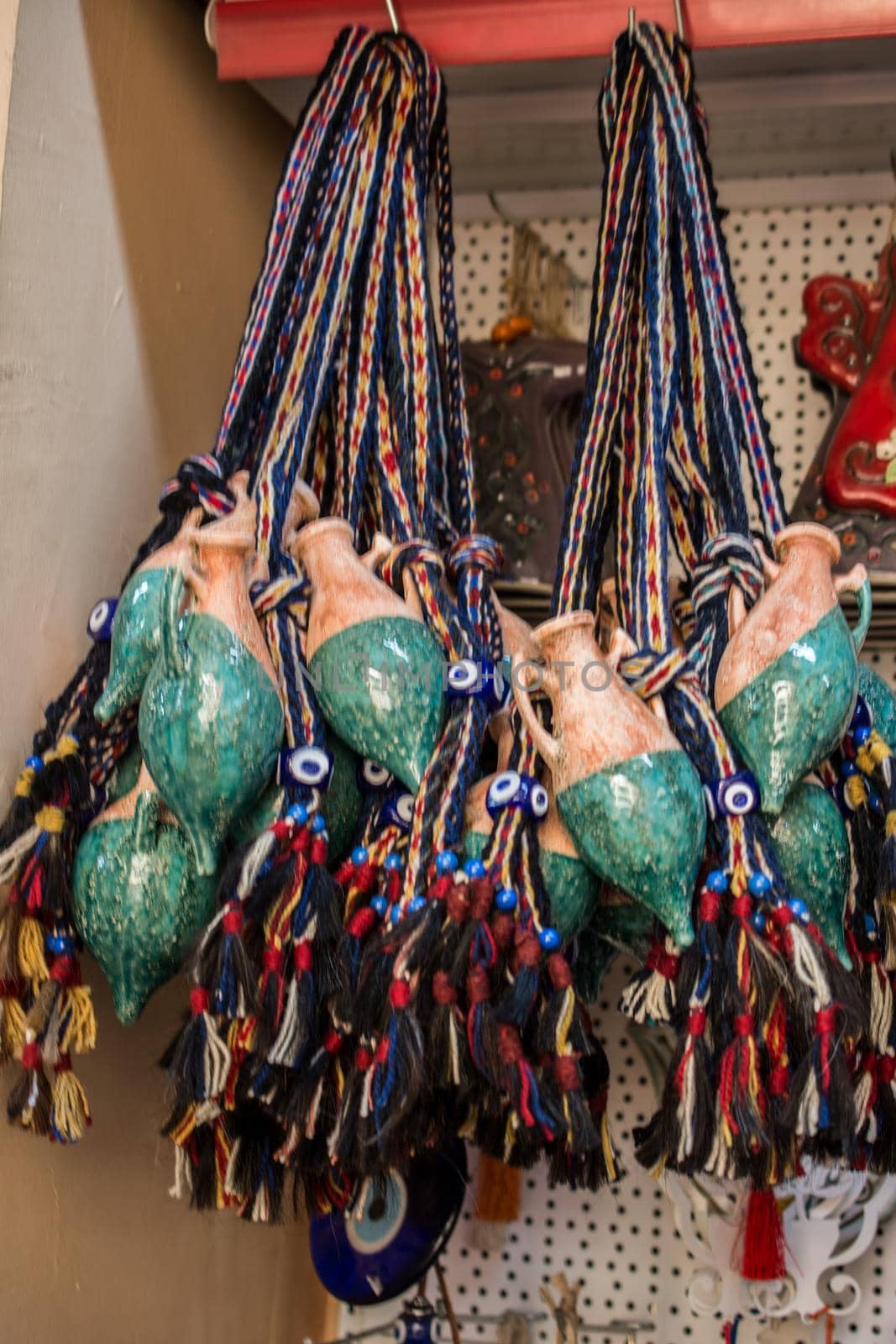 Miniature clay pitchers hanging in a store on display
