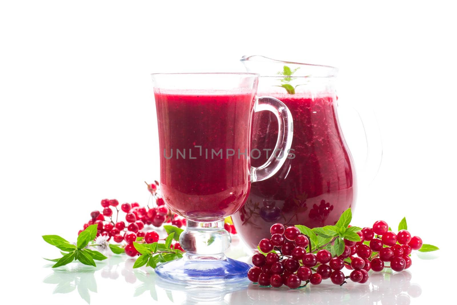 freshly squeezed thick natural juice with pulp of ripe red viburnum in a decanter on a white background