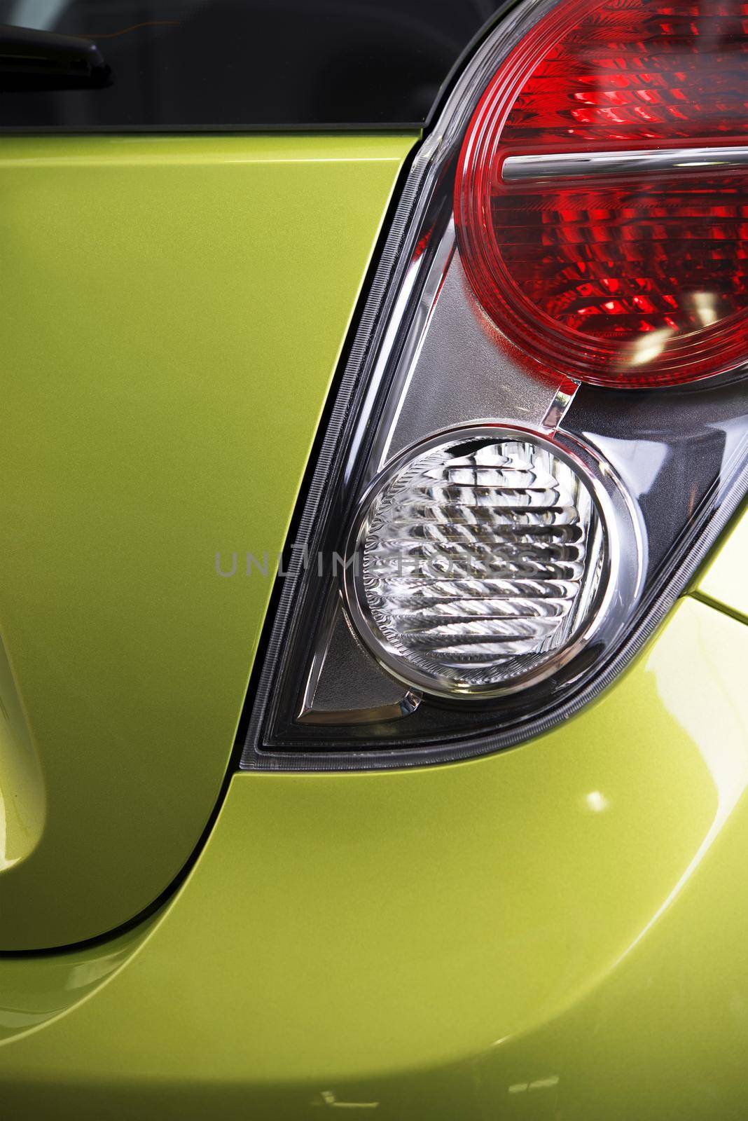 Rear Vehicle Lights. Reverse and Stop Lights Closeup. Green Vehicle Body. Transportation Photo Collection.