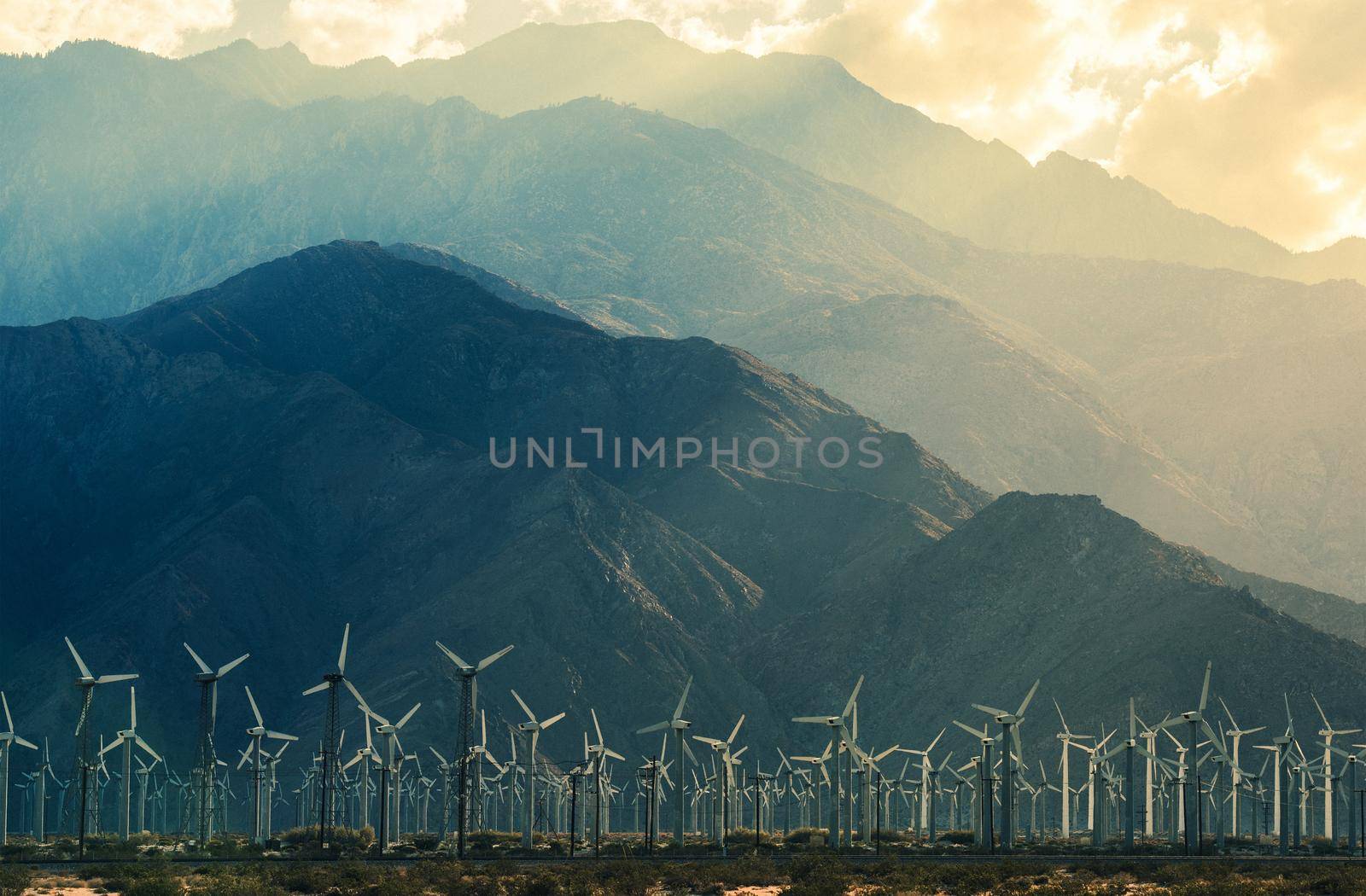 California Desert Wind Turbines in Coachella Valley. Scenic Mountains and Sun Light. California, United States.