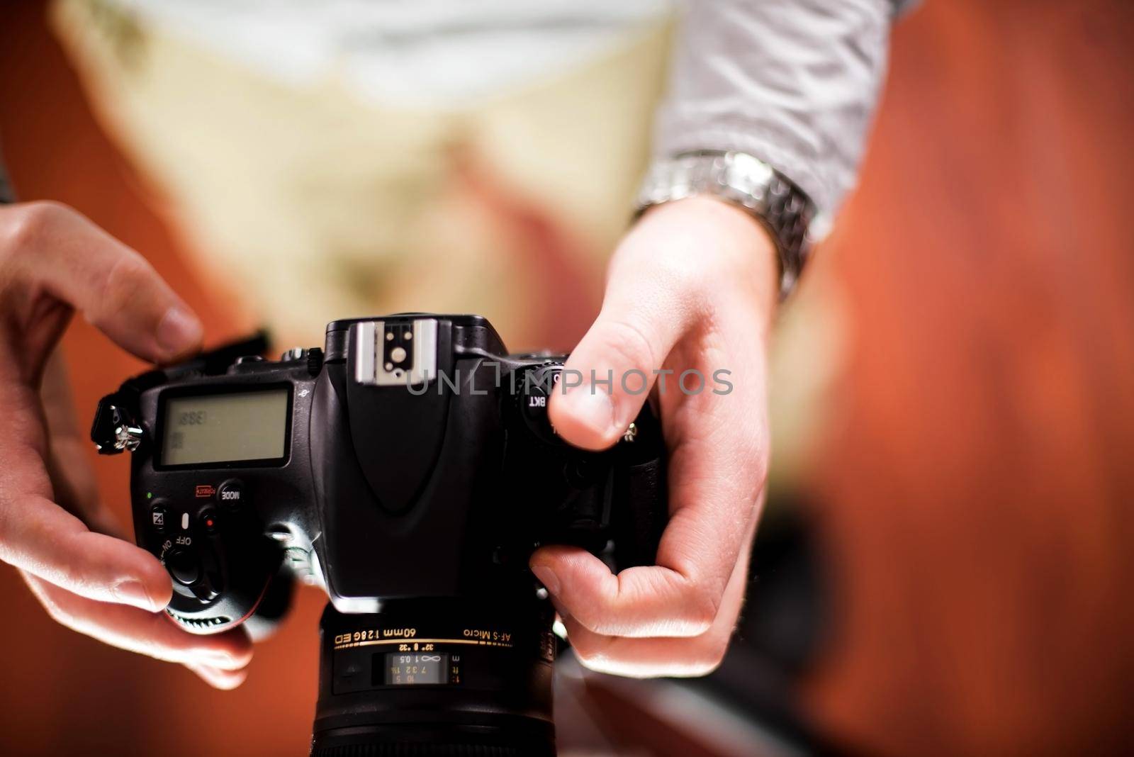 Professional Camera in Hands of Photographer. Photography Theme. Top View - Male Hands. Technology Photo Collection.