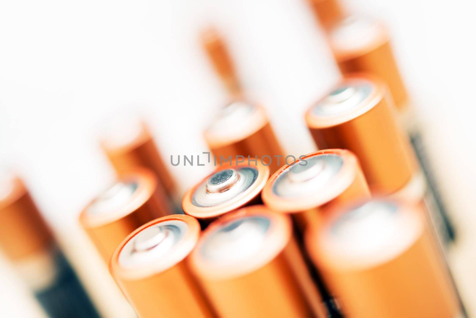 AA Standing Golden Batteries Isolated on White. Mobile Energy Source.