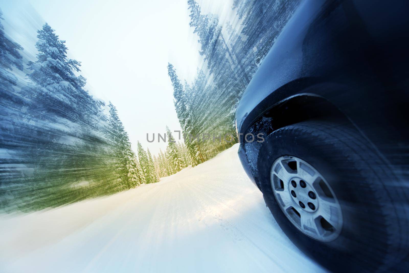 Speeding Car on Countryside Winter Road. Road Covered by Heavy Snow. Motion Blur.
