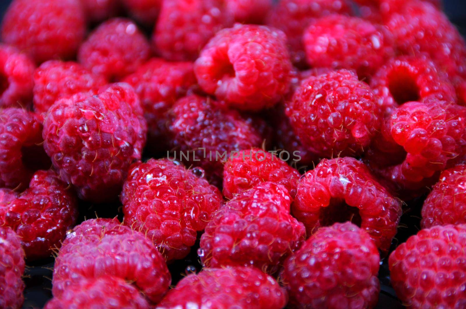 Fresh Rasberries Background. by welcomia