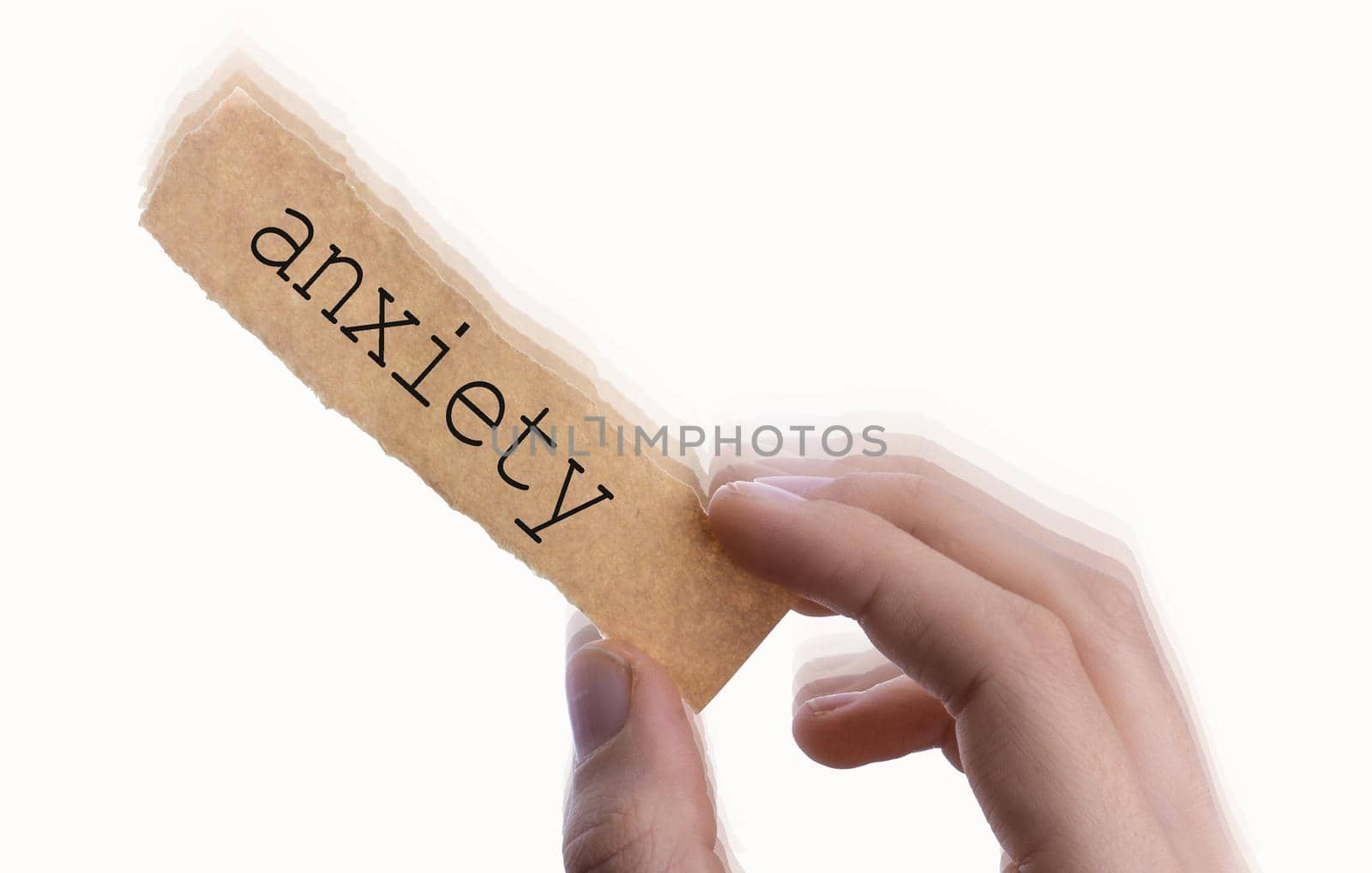 hand holding a piece of blank torn notepaper with  Anxiety wording