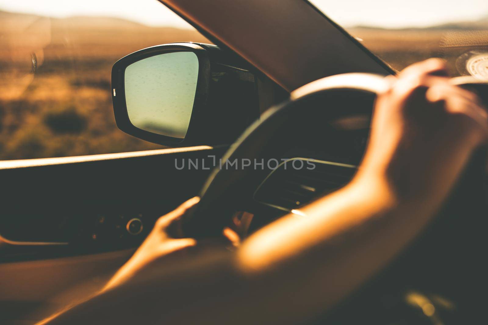 Hands on Steering Wheel Summer Trip Closeup. Car Driving