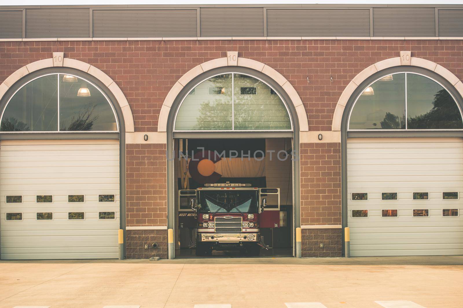 Firefighters of Colorado. Fire Truck inside Firehouse. Large Colorado Flag on the Wall. Colorado Fire Department. by welcomia