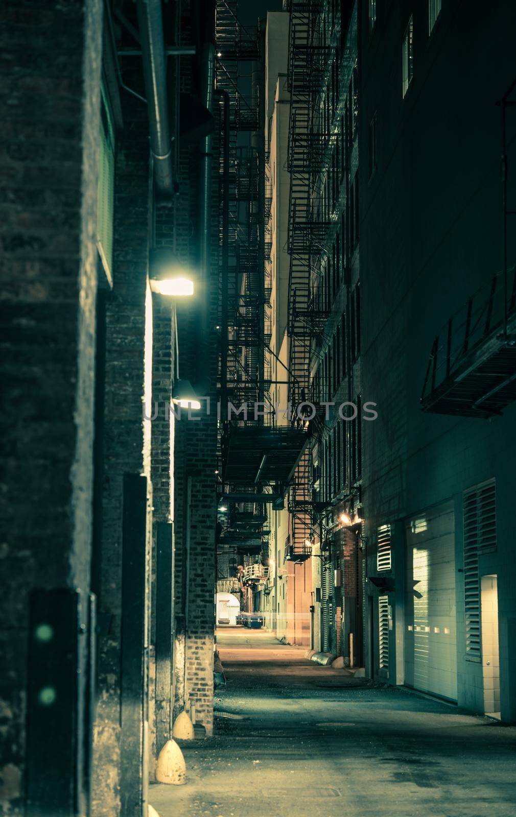 Dark and Spooky Chicago Alley in Greenish Color Grading. Vertical Chicago Alley Photo.