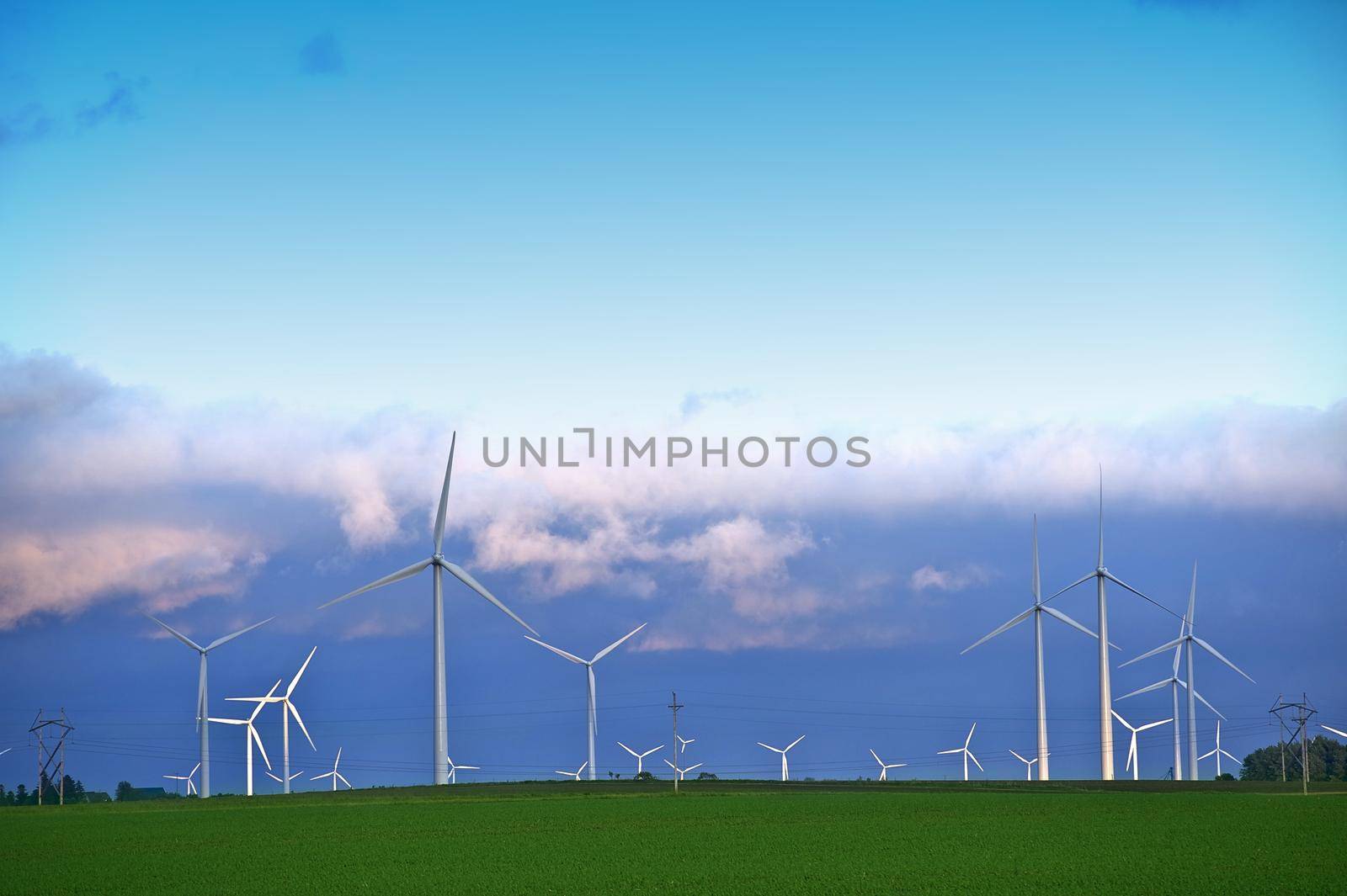 Alternative Energy Landscape - Wind Turbines Farm in Minnesotas Mower County near Dexter, MN. Wind Turbines in Sunset