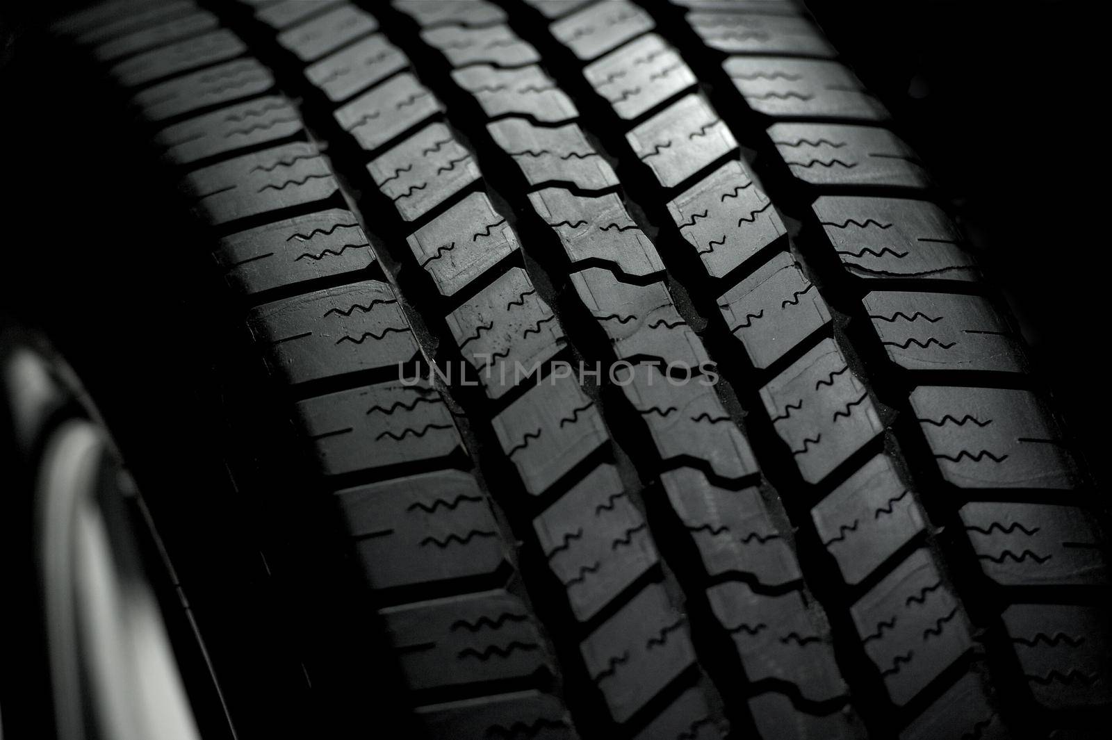 Car Tire on Black Background. Car Tire in the Dark - Spot Light by welcomia