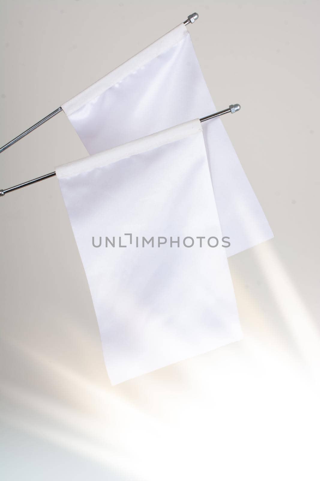 Two white flags on a white background in display by berkay
