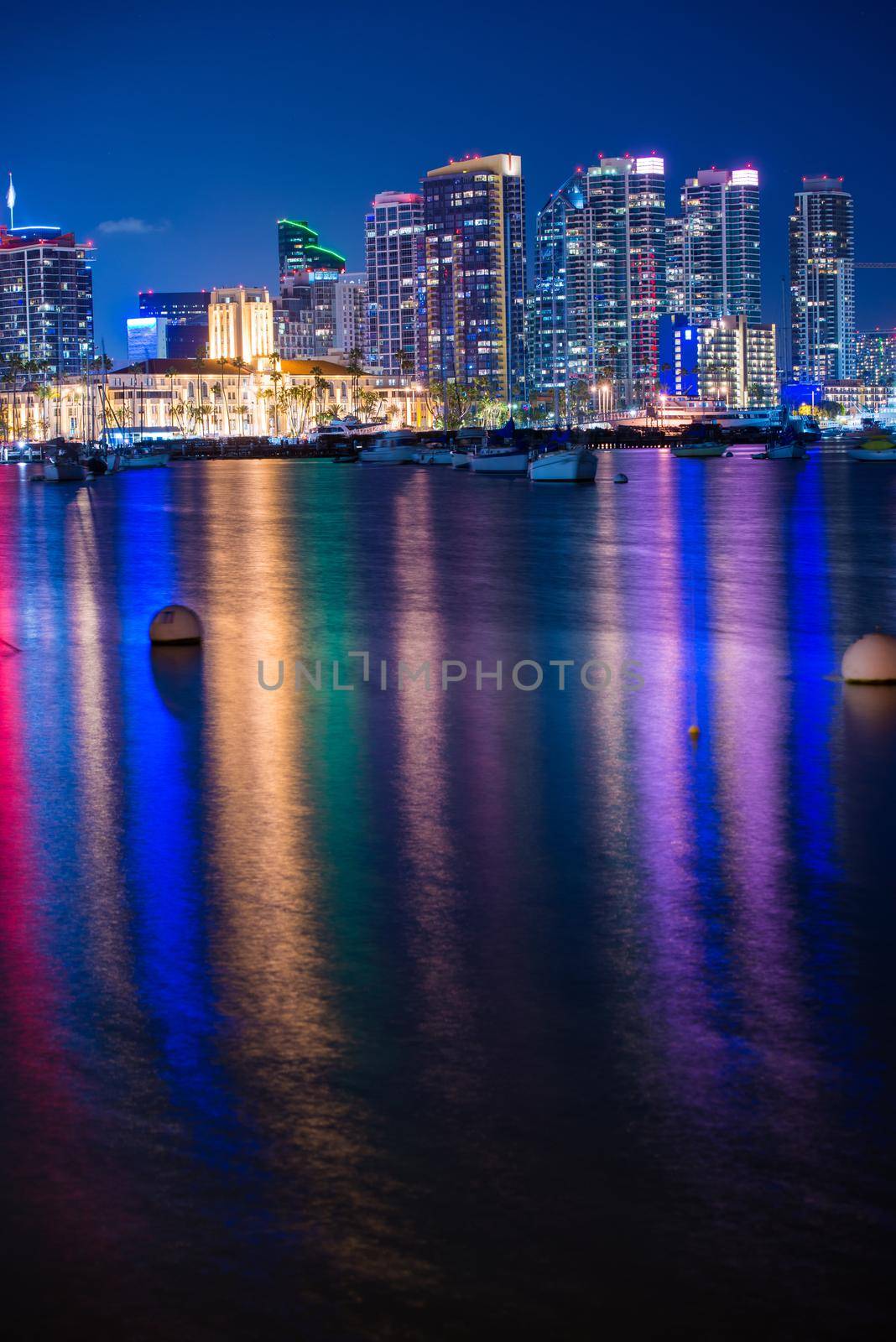 Colorful San Diego Night in Vertical Photography. San Diego Skyline and the Bay with Colorful Water Reflection. San Diego, CA, USA. by welcomia