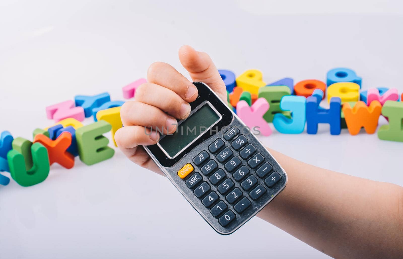 Little calculator in hand with colorful letters behind by berkay