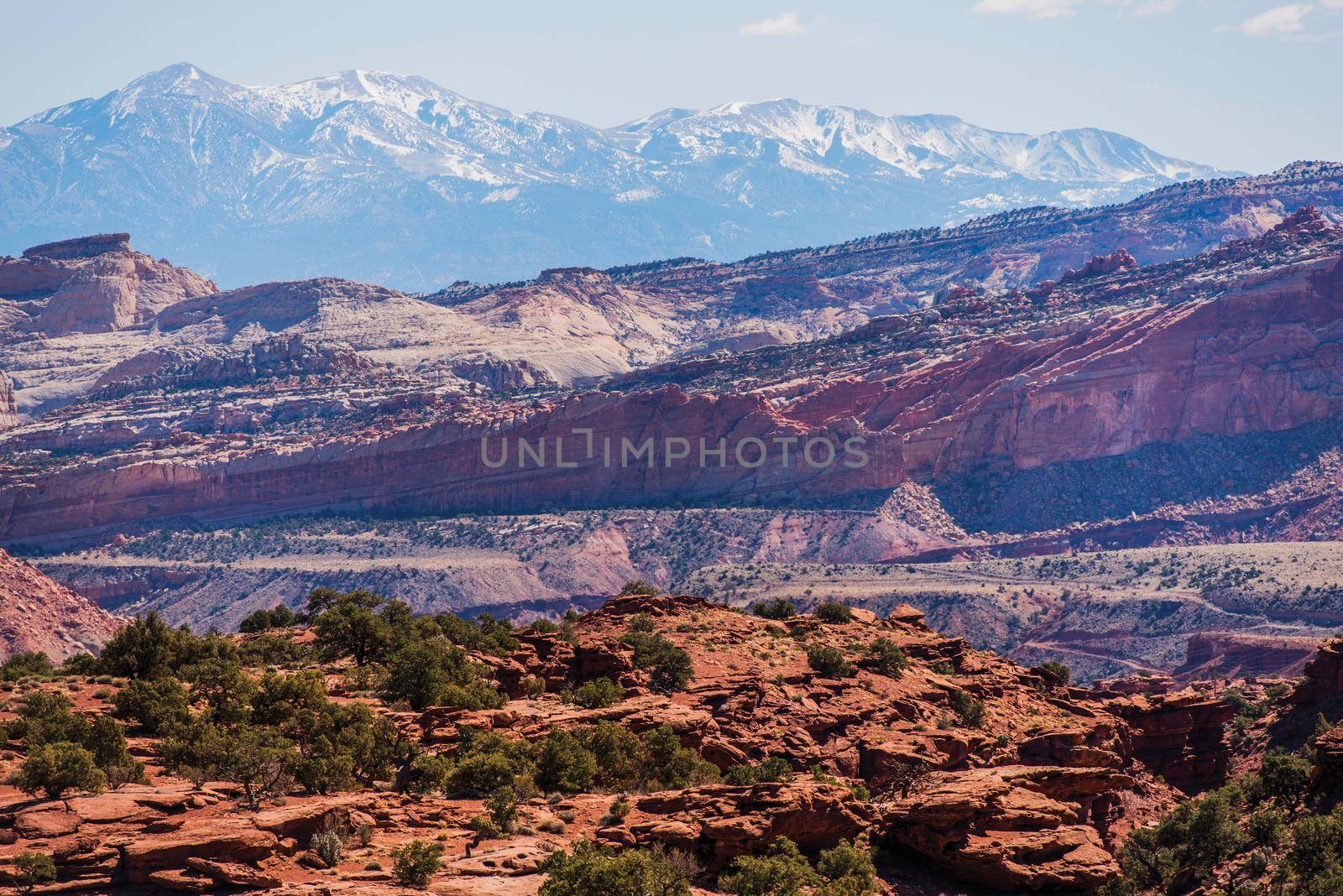 Colorful Utah Landscape. Red Sandstones In the Front and Snowy Mountains in the Back. Capitol Reef National Park. South Central Utah State. by welcomia