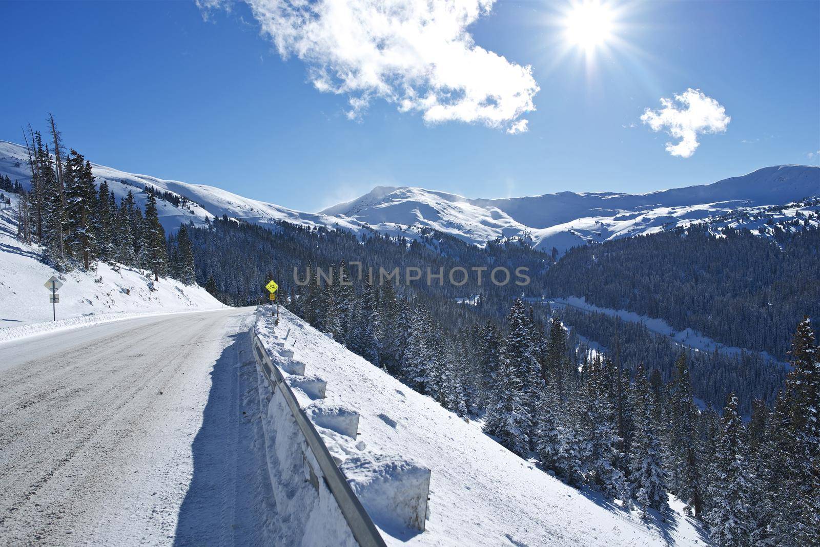 Winter Drive in Colorado. Mountain Road Covered by Snow and Ice. Colorado, United States. by welcomia