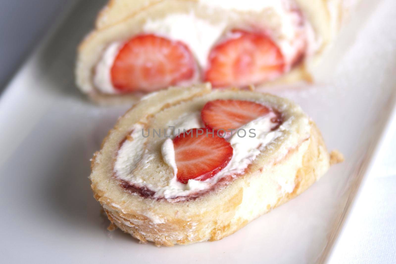 A fresh strawberry and cream roularde swiss roll