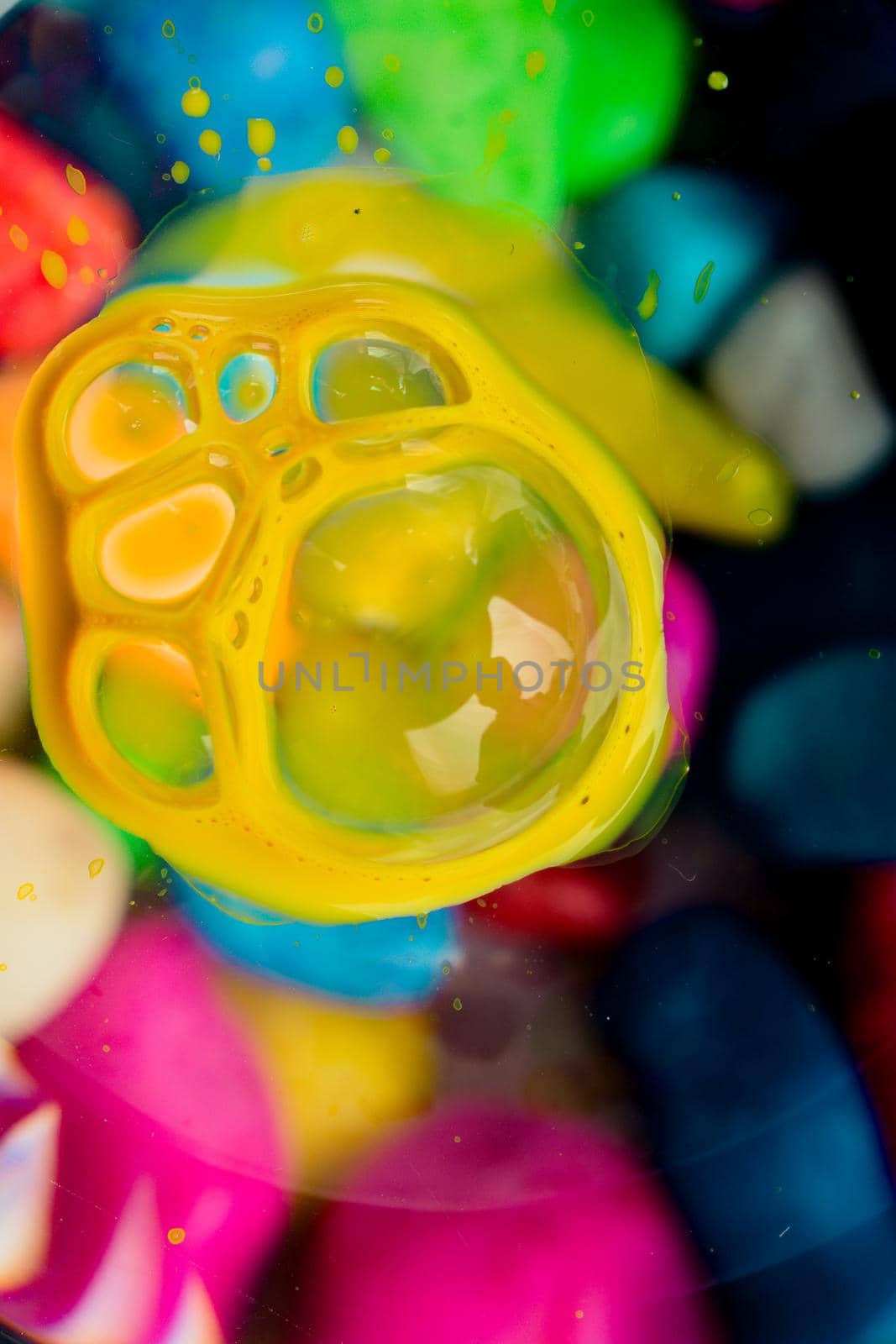 Colorful paint bubbles on a glass by berkay